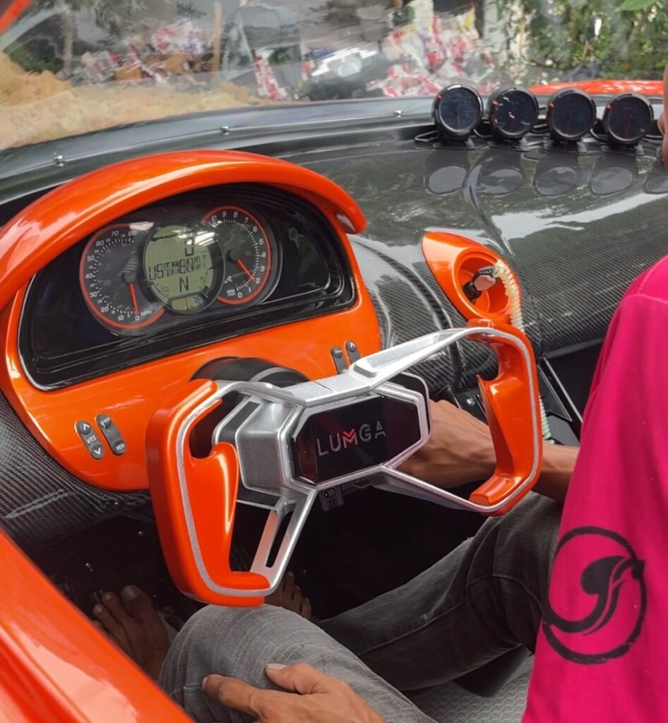 LUMGA technician applying custom paint to a high-performance Jetcar.